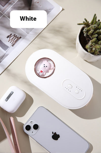 Dark green paw-shaped hand warmer and power bank with a cute bear design, held in a hand with white faux fur gloves. - Image 14
