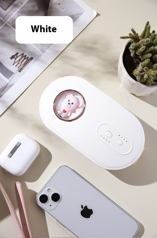 Dark green paw-shaped hand warmer and power bank with a cute bear design, held in a hand with white faux fur gloves. - Image 14