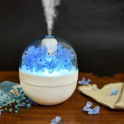 White spherical aroma diffuser with clear dome, featuring preserved blue roses, blue hydrangea, and a white rabbit figurine. - Image 11