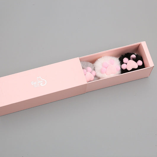 Three fluffy cat toy balls in white with pink paw print, gray, and black, next to a pink gift box. - Image 8