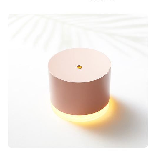 Pink cylindrical mini wireless humidifier with a clear base and a small gold mist outlet on top. - Image 8