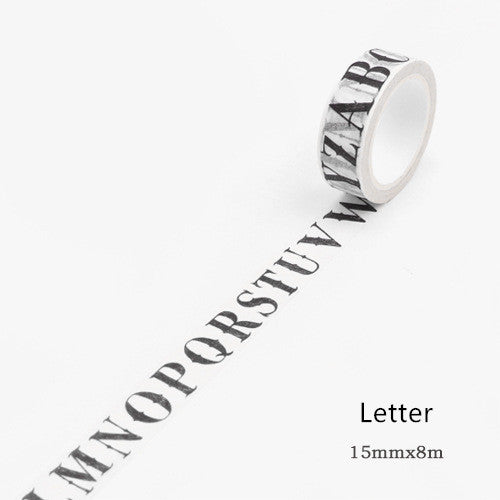 Washi tape with a black gothic-style alphabet letter pattern on a white background, showing a partial alphabet.