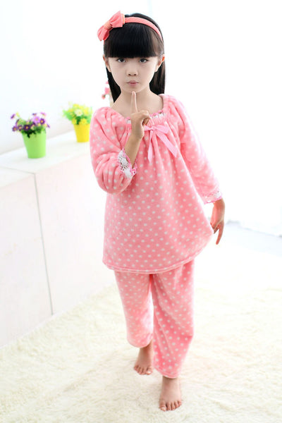 Young woman wearing a pink coral fleece thermal pajama set with white and red polka dots and ruffled hems. - Image 7