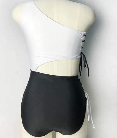 Black and white one-piece bikini with a one-shoulder white top and high-waisted black bottom, featuring lace-up sides. - Image 10