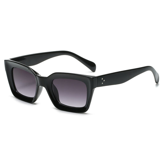 Black vintage-style sunglasses with thick plastic frames and dark rectangular lenses, featuring a subtle cat-eye shape. - Image 6