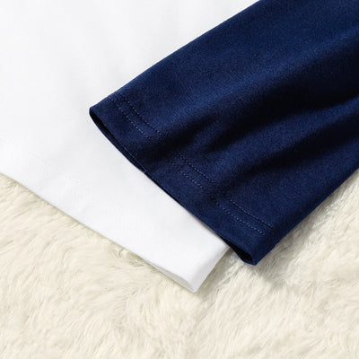 Matching family Christmas pajamas with white and navy blue long-sleeve tops, reindeer print, and "Merry Xmas!" text. - Image 4