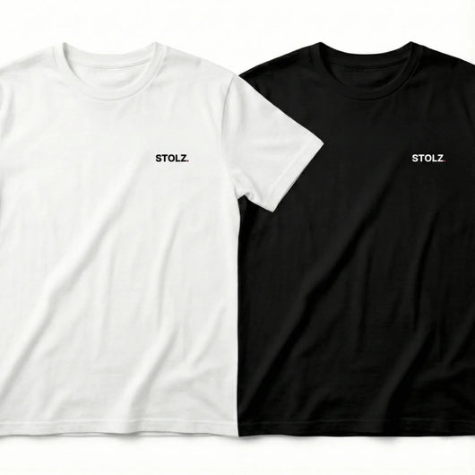Two loose-fitting short-sleeve t-shirts, one white and one black, both with 'STOLZ' text on the chest.