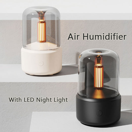 White cylindrical aroma diffuser with a clear top and an amber candlelight-effect LED light. - Image 2