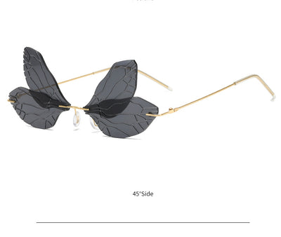 Light green rimless butterfly sunglasses with gold metal frames, featuring a unique veined lens design. - Image 19