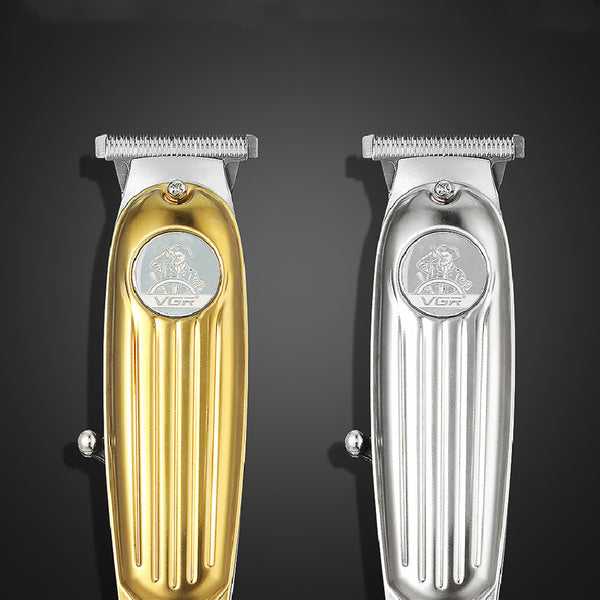 Silver electric hair clipper with cord, 1mm, 2mm, 3mm guide combs, cleaning brush, spray bottle, and manual.