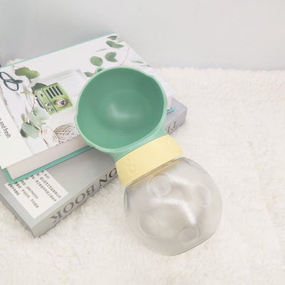 Portable pet water bottle with white drinking bowl, translucent grey reservoir, and yellow paw print band. - Image 4