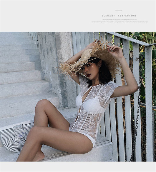 White lace cut-out one-piece swimsuit with short sleeves and a deep V-neckline, modeled by a woman. - Image 16