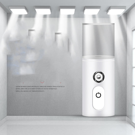 White portable facial humidifier with a clear water tank and a power button, for on-the-go moisturizing. - Image 5