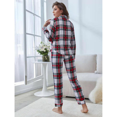 Woman wearing a red, white, and green plaid two-piece pajama set with a button-up top and long pants. - Image 4