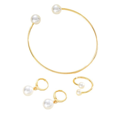 Gold-tone open cuff bracelet, matching open ring, and dangle earrings, all featuring white faux pearls. - Image 5