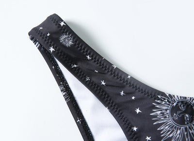 Black celestial print bikini set with a bandeau tie-front top and high-cut bottoms, featuring sun, moon, and star patterns. - Image 13