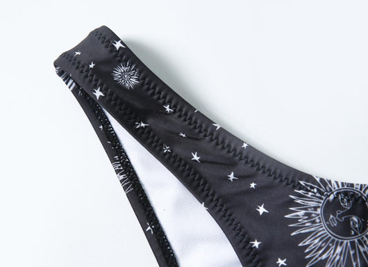 Black celestial print bikini set with a bandeau tie-front top and high-cut bottoms, featuring sun, moon, and star patterns. - Image 13