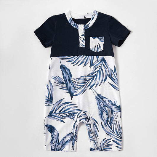 Young boy wearing a white short-sleeve t-shirt with blue tropical leaf print and a black chest pocket. - Image 22