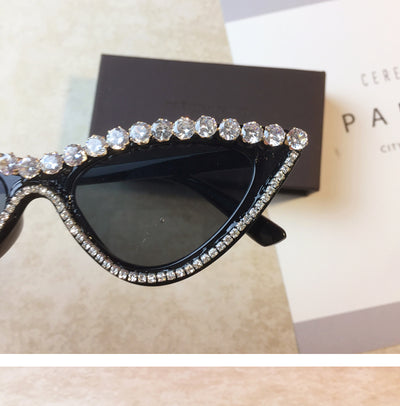 Two pairs of cat-eye sunglasses, one black with clear rhinestones and one pink with pink rhinestones, on a light surface. - Image 6