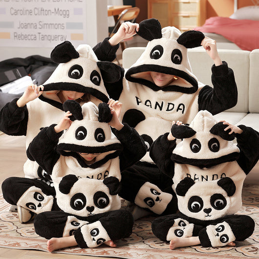 Family wearing matching black and white panda plush housewear suits with hoods and checkered pants, posing indoors. - Image 12