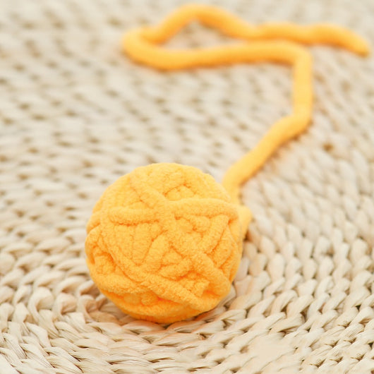 Colorful plush yarn ball cat toy in pink, blue, and white, with a long trailing strand, on a light background. - Image 34