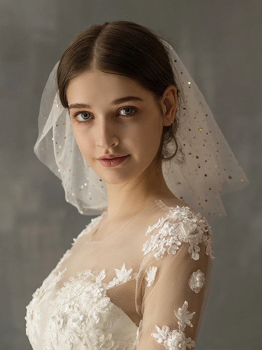 White multi-layer short bridal veil with gold star embellishments, worn by a model in a white lace wedding dress. - Image 10