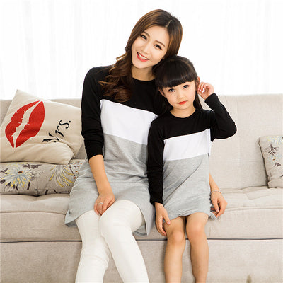 Matching black, white, and grey colorblock long-sleeved t-shirts for couples, worn by a man and a woman. - Image 13