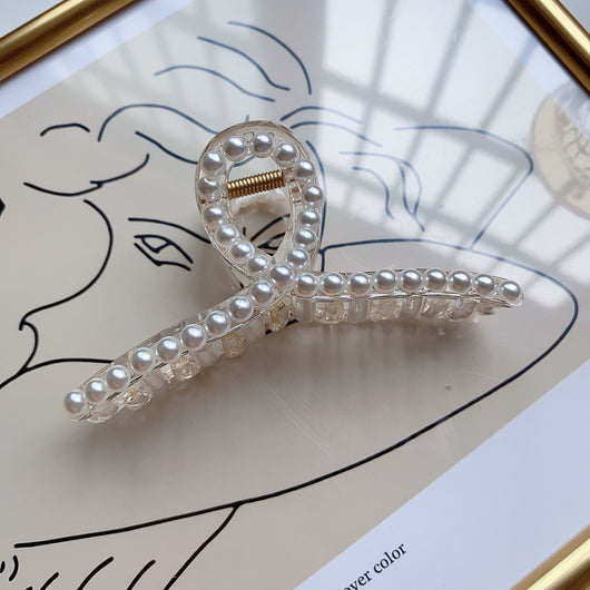Clear plastic hair claw clip adorned with a single row of white faux pearls and a gold-toned spring. - Image 14