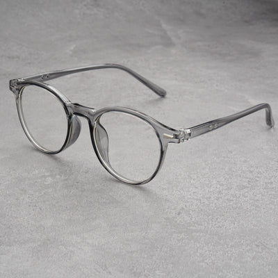 Fashionable round-frame sunglasses with transparent gray frames and dark gray lenses on a gray surface. - Image 9