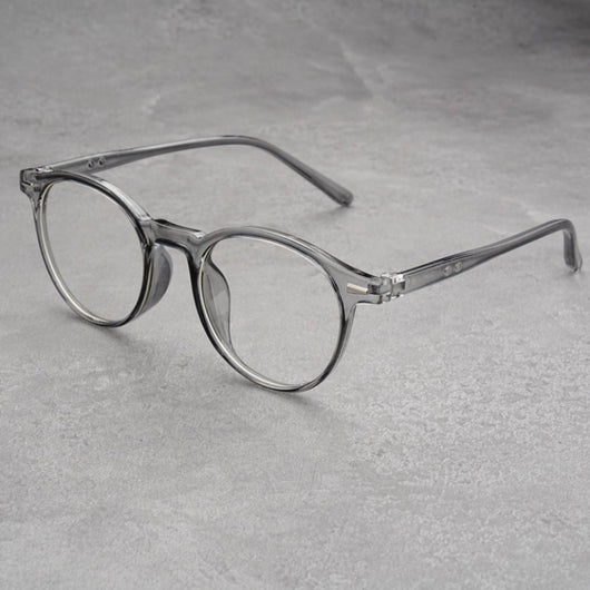 Fashionable round-frame sunglasses with transparent gray frames and dark gray lenses on a gray surface. - Image 9
