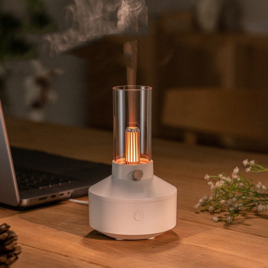 White vintage lamp-style humidifier with clear top, gold element, USB cable, user manual, and six essential oils.
