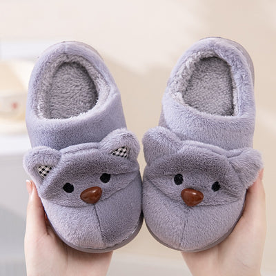 Pair of gray plush bear slippers with checkered ears and brown noses, held up against a soft background. - Image 3
