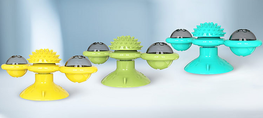 Green windmill cat toy with suction cup base, spinning arms, textured ball, and colorful lights, being played with by a tabby cat. - Image 6
