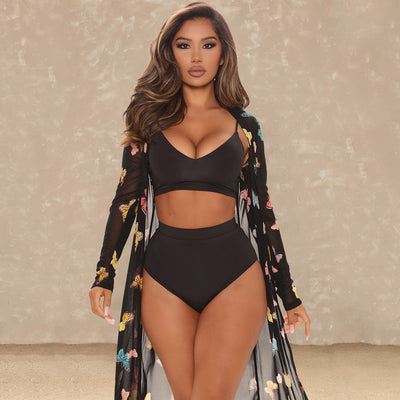 Women's black three-piece swimsuit with a mesh butterfly print shawl, V-neck bikini top, and high-waisted bottoms.