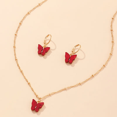 Blue resin butterfly necklace and earring set with gold-tone chains and findings, displayed on a light background. - Image 15
