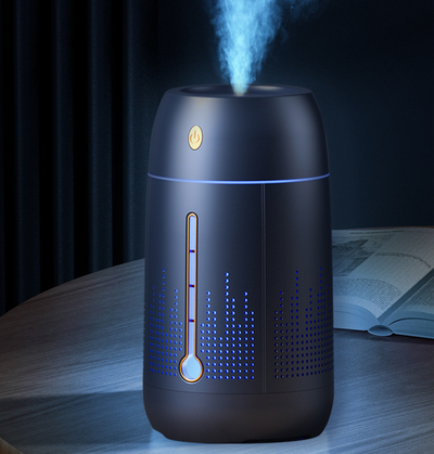 White cylindrical household humidifier with a visible water level indicator, next to its brown cardboard packaging. - Image 18