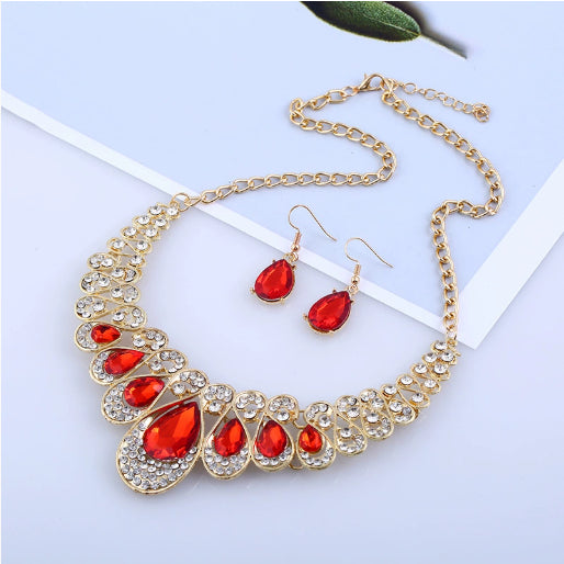 Gold-tone necklace and matching drop earrings set with clear teardrop gems and sparkling rhinestones. - Image 7
