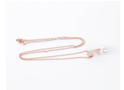 Rose gold-toned necklace and drop earrings set with white spherical pearls and clear rhinestone accents. - Image 5