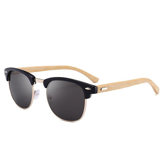 Clubmaster sunglasses with black upper frames, gold-tone metal lower rims, blue mirrored lenses, and light wood-look temples.