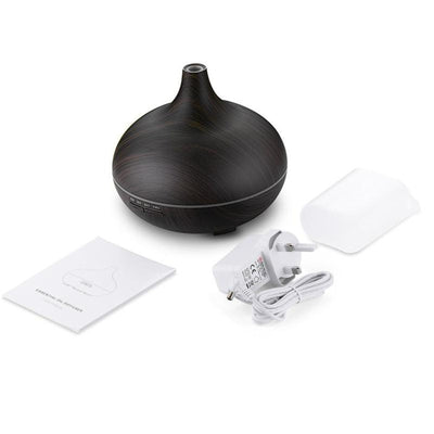 Wood grain ultrasonic aromatherapy diffuser and humidifier with a glowing blue LED light band and control buttons. - Image 6