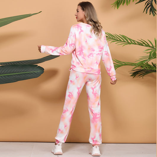 Woman wearing a pink and white tie-dye long-sleeve top and matching pants set, posing casually. - Image 7
