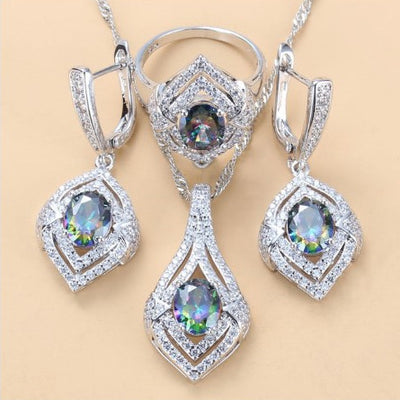 Silver-toned three-piece jewelry set with clear oval and round gems, including a necklace, dangle earrings, and a ring. - Image 15