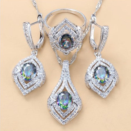 Silver-toned three-piece jewelry set with clear oval and round gems, including a necklace, dangle earrings, and a ring. - Image 15