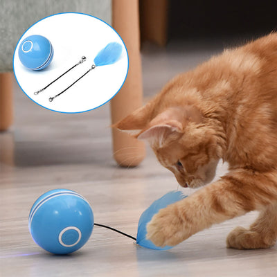 Pink automatic cat toy ball with a power button, shown with detachable feather and bell accessories.
