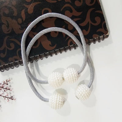 Magenta elastic curtain tieback with two white pearl-beaded spheres, designed to hold curtains elegantly. - Image 4