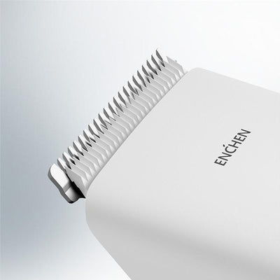 Black cordless hair shaver with a comb attachment and two white indicator lights, with a blurred white shaver in the background. - Image 3