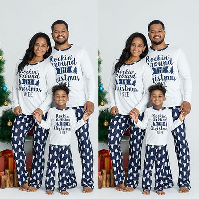 Family of three wearing matching white and navy blue Christmas pajamas with "Rockin' around THE Christmas TREE" text. - Image 4