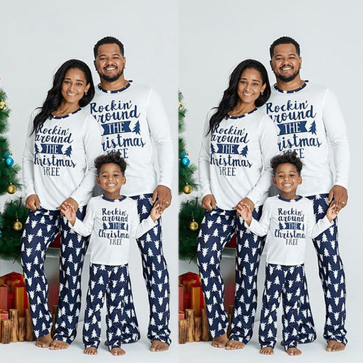 Family of three wearing matching white and navy blue Christmas pajamas with "Rockin' around THE Christmas TREE" text. - Image 4