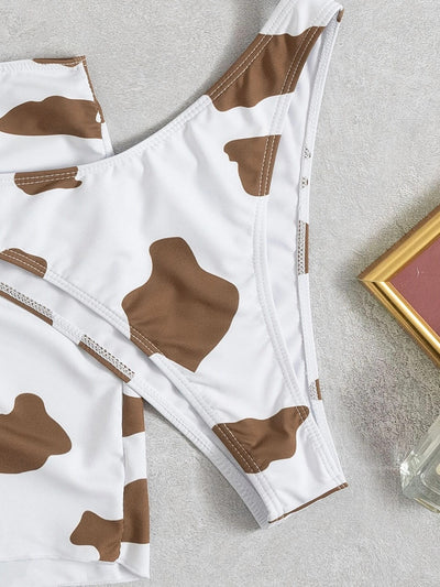 Women's three-piece cow print swimsuit with a white and brown triangle bikini top and a ruched mini skirt. - Image 10