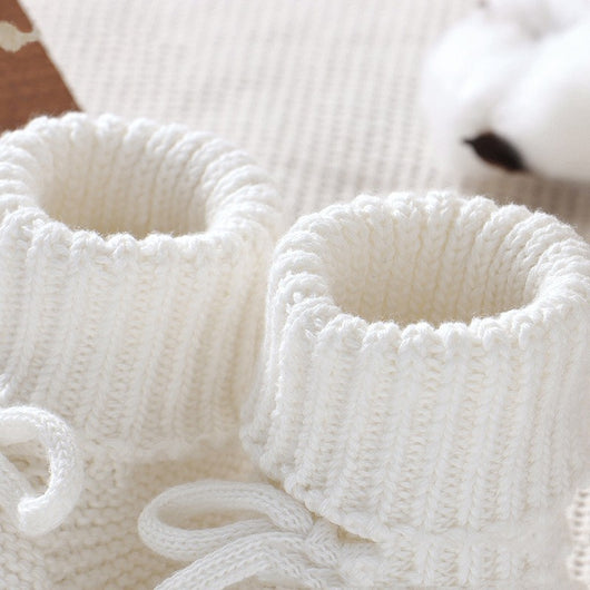 Pink knitted infant toddler shoes with cute bowknots and elastic bands, displayed on a soft white rug. - Image 13